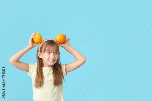 Funny little girl with oran...