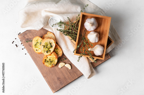 Composition with toasted bread and garlic on light background