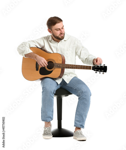 Young man playing guitar on white background