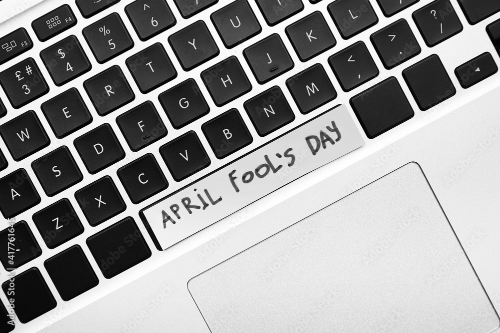 Laptop with text APRIL FOOL'S Day, closeup Laptop with text APRIL FOOL'S Day, closeup