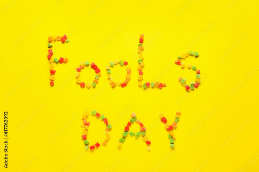Text FOOLS DAY made of marmalade on color background
