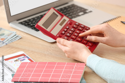 Woman with calculator worki...