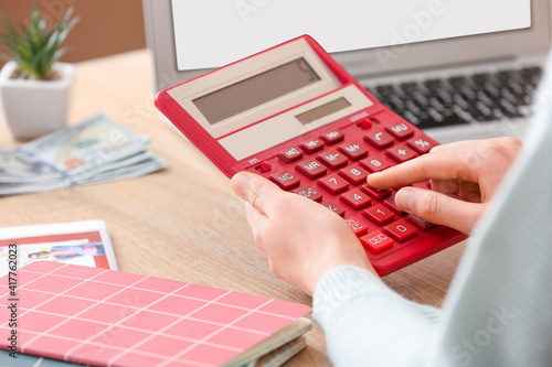 Woman with calculator worki...