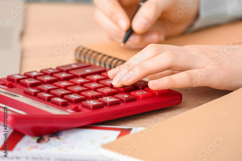 Woman with calculator worki...