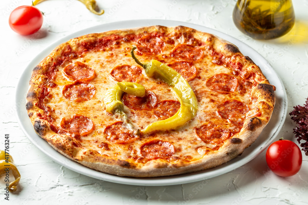 American pizza with pepperoni, mozzarella and tomato sauce. Top view of hot pepperoni pizza. Traditional italian pizza American pizza with pepperoni, mozzarella and tomato sauce. Top view of hot pepperoni pizza. Traditional italian pizza