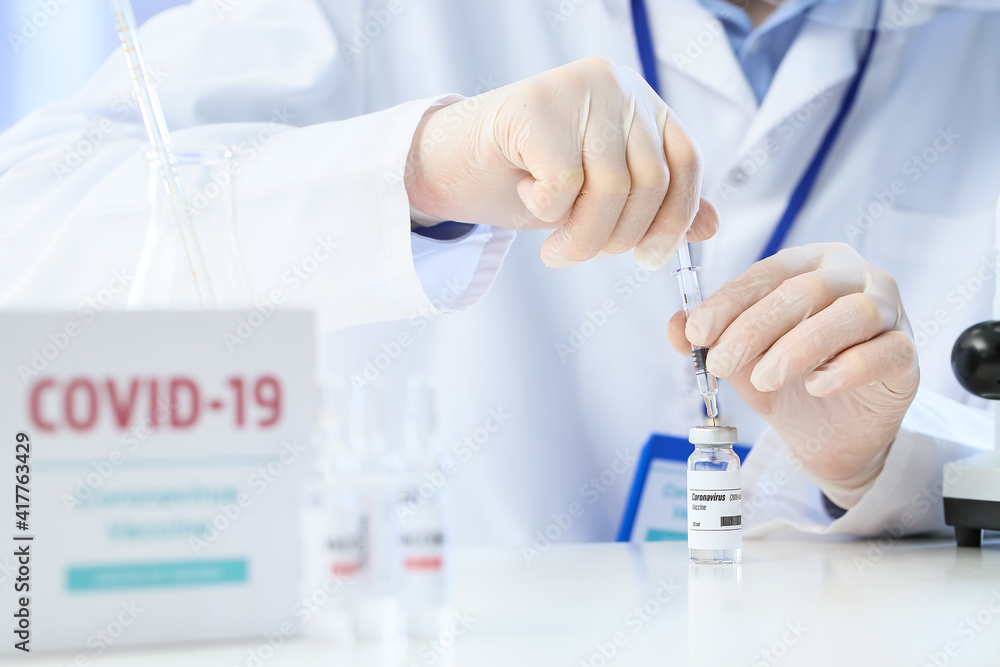 Scientist developing vaccine against COVID-19 in laboratory, closeup
