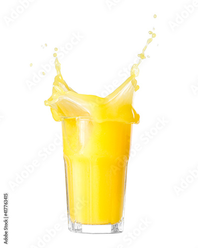 Glass of orange juice with splash on white background