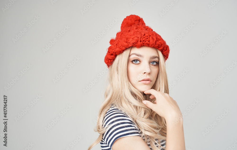 soap woman in a red hat in a striped t-shirt on a gray background blonde soap woman in a red hat in a striped t-shirt on a gray background blonde