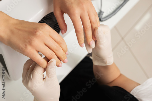 process of hand massage. clean fair skin, well-groomed manicure, unrecognizable people photo
