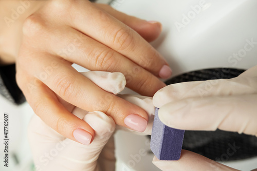 process of manicure and hand massage. clean fair skin, well-groomed manicure, unrecognizable people, selective focus photo