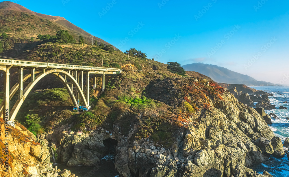 Aerial view from a drone, Bixby Creek Bridge on Highway One on the US West Coast heading south to Los Angeles, Big Sur, California, beautiful scenery, cliffs, Pacific Ocean. Concept, vacation, tourism