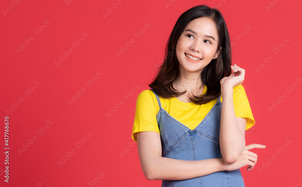 Asian beautiful girl with short hair shoulder wearing a yellow blouse With short skirt Standing with arms folded Standing smiling beautifully With the concept ideas for advertising. Asian beautiful girl with short hair shoulder wearing a yellow blouse With short skirt Standing with arms folded Standing smiling beautifully With the concept ideas for advertising.