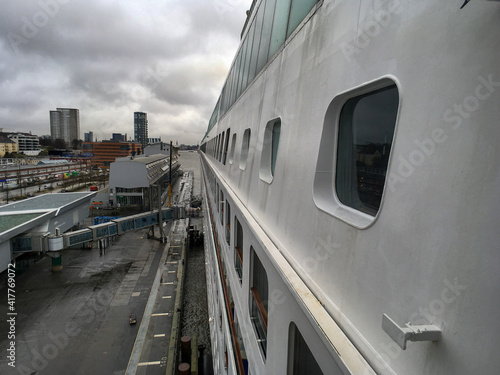 View from navigational bridge over side of modern cruiseship or cruise ship liner to the aft rear Stern along portside hull in port