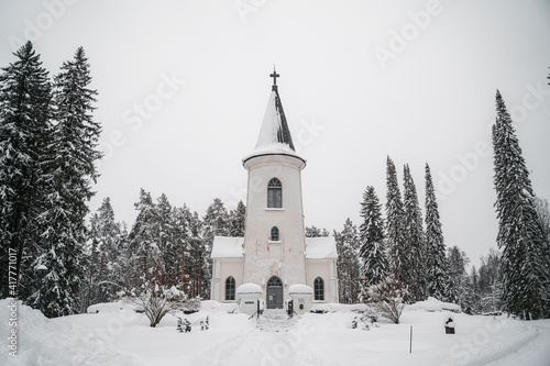 Small chapel church in woods during snowy winter
