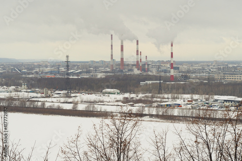 Industrial city by the river in winter. The infrastructure of