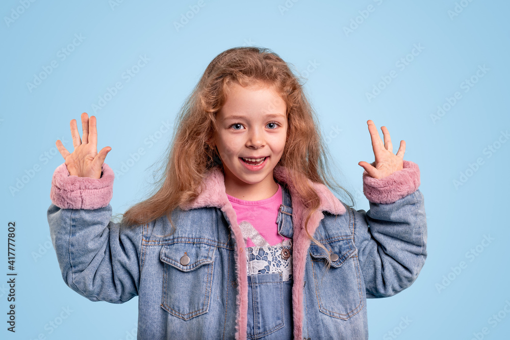 Happy girl in denim clothes showing 10 fingers Happy girl in denim clothes showing 10 fingers