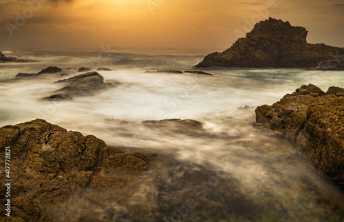 Long exposure water, beautiful seascape, ocean views, rocky coastline, sunlight on the horizon. Composition of nature. Sunset scenery background. Cloudy sky. California coast.