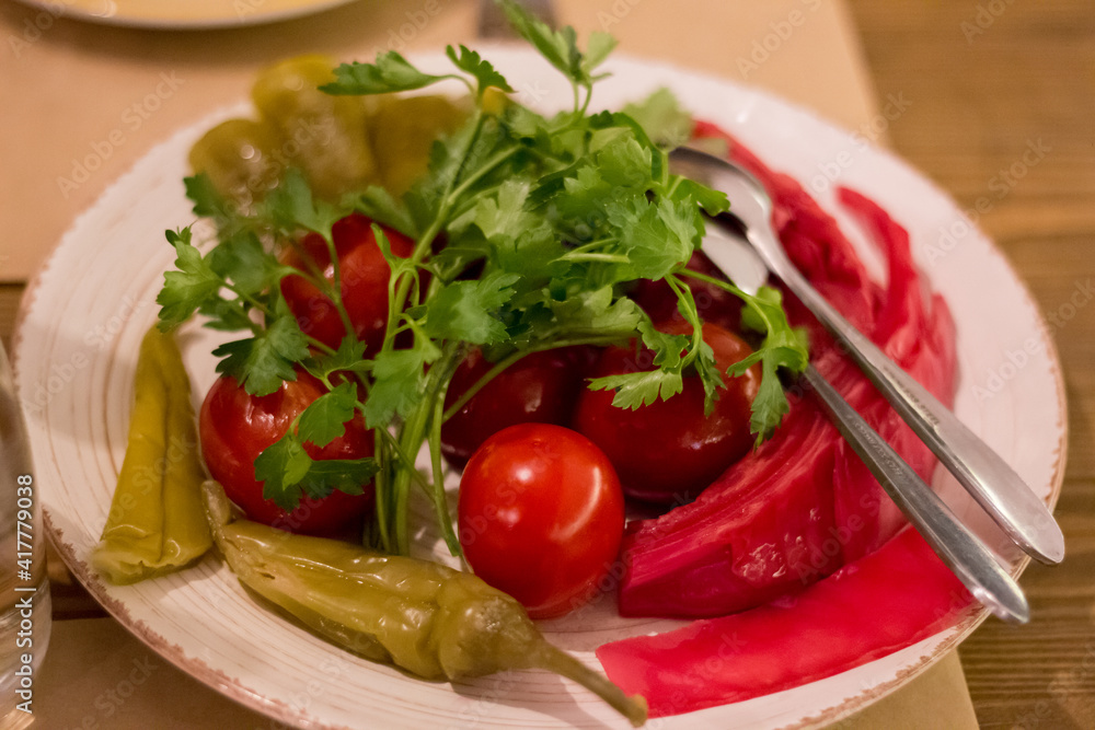 Canned vegetables - tomatoes, peppers, cabbage, on a plate