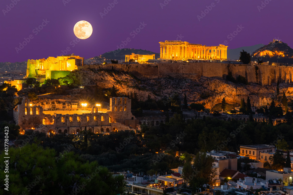 Sunset view on Acropolis in Athens, Greece at with full moon. Travel in Greece