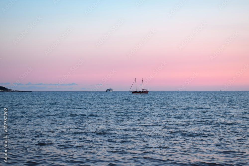 Black Sea at sunset in pink and blue pastel colors. Ships on the horizon Black Sea at sunset in pink and blue pastel colors. Ships on the horizon