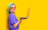 girl with orange glasses and laptop computer