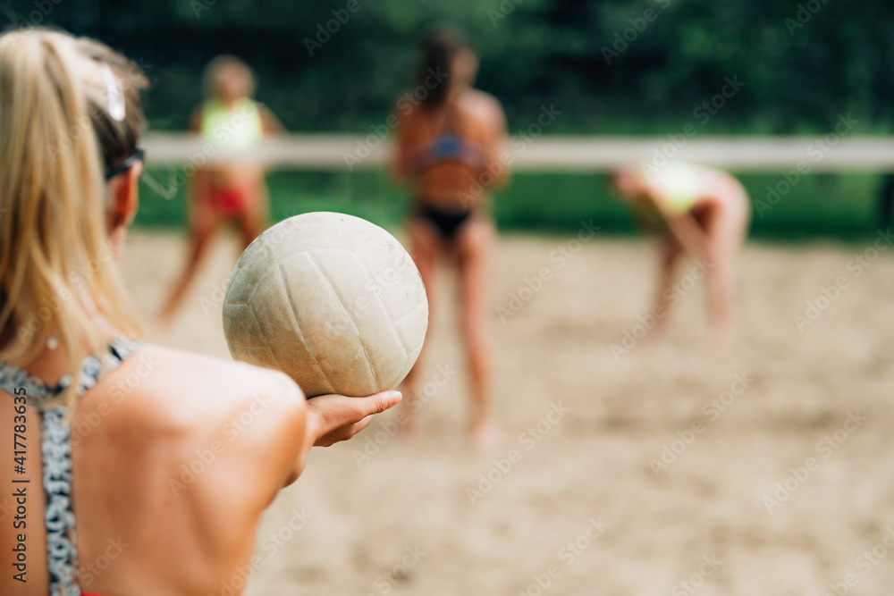 Beach Volleyball, Female Player Serving the Ball