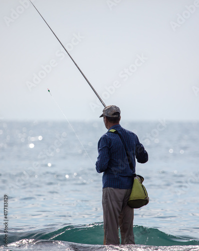 A man with a fishing rod is fishing