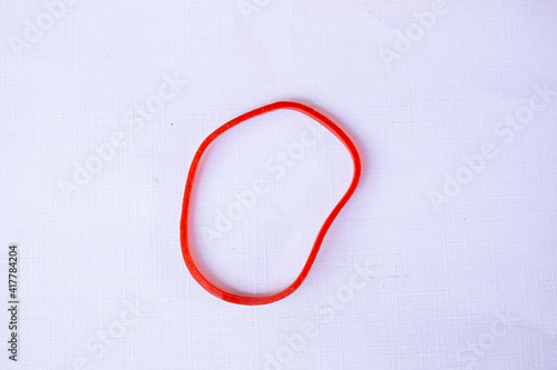 red rubber band. Elastic bands. dragging an elastic band, isolated on white background
