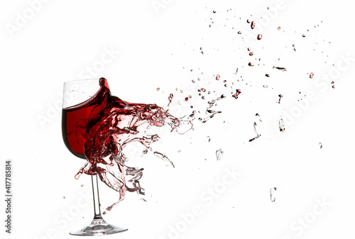 Explosion of a glass with red wine isolated on white.