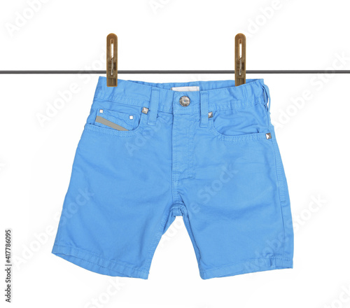 Blue jeans shorts with drying on clothesline isolated on white