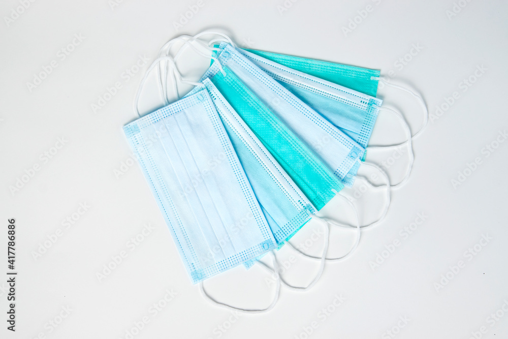 Surgical mask on white background, close-up. Surgical mask on white background, close-up.