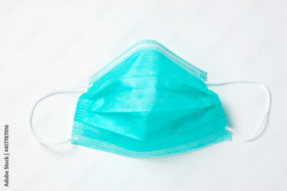 Surgical mask on white background, close-up. Surgical mask on white background, close-up.