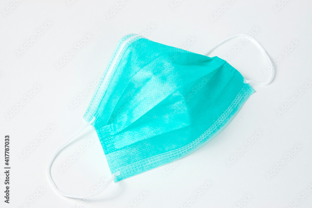 Surgical mask on white background, close-up. Surgical mask on white background, close-up.