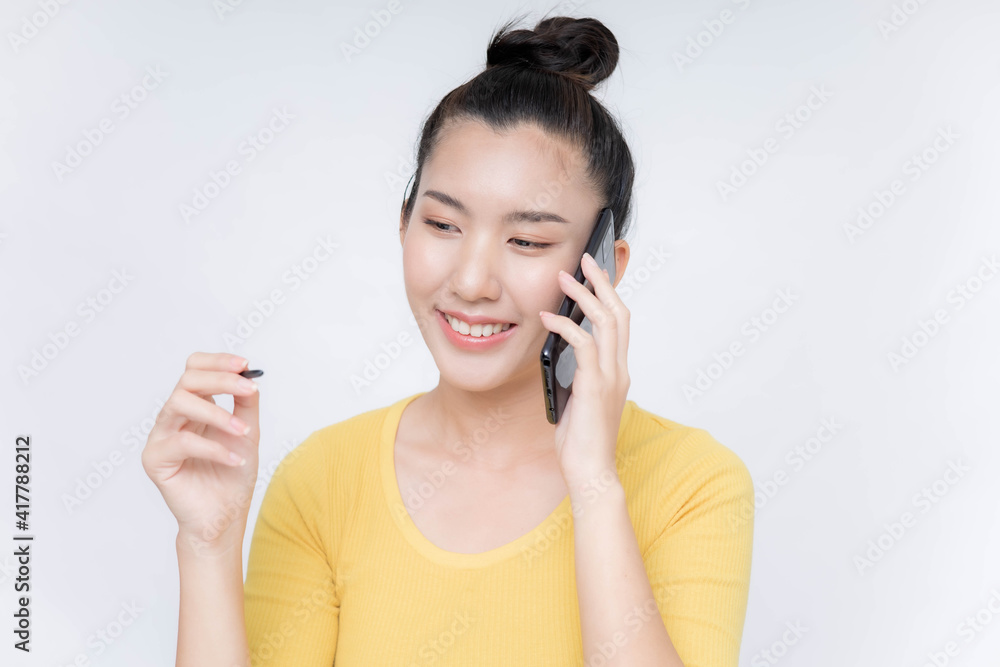 Young Asian woman lying on mobile phone Young Asian woman lying on mobile phone