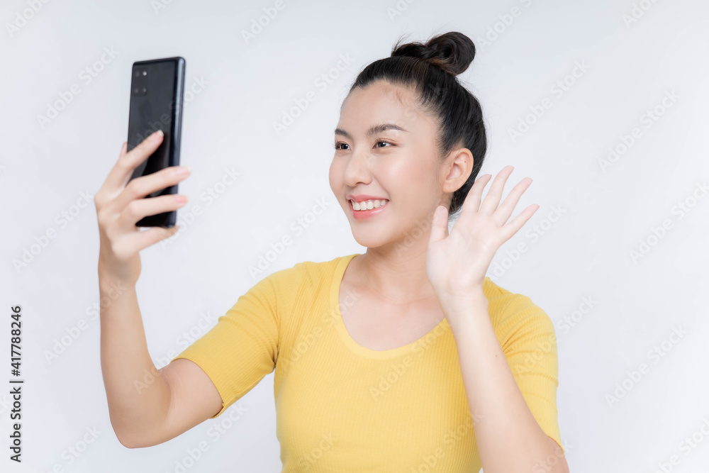 Young Asian woman lying on mobile phone Young Asian woman lying on mobile phone