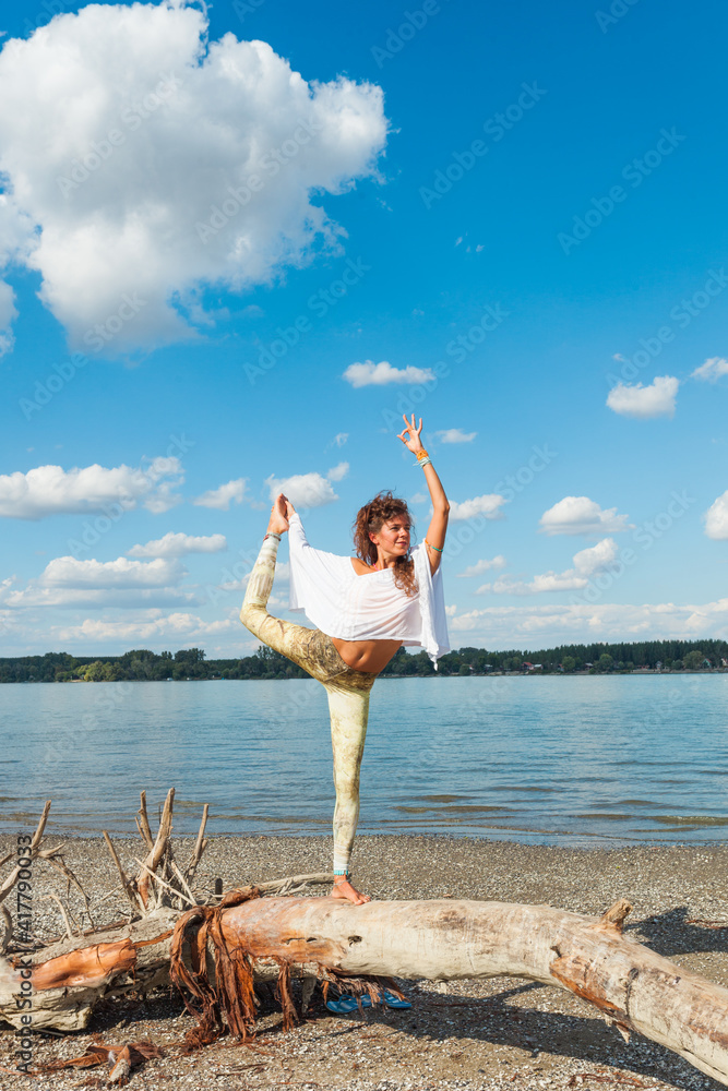 healthy lifestyle young woman practice yoga on dried trunk on the river beach fresh air sunny summer day healthy lifestyle young woman practice yoga on dried trunk on the river beach fresh air sunny summer day