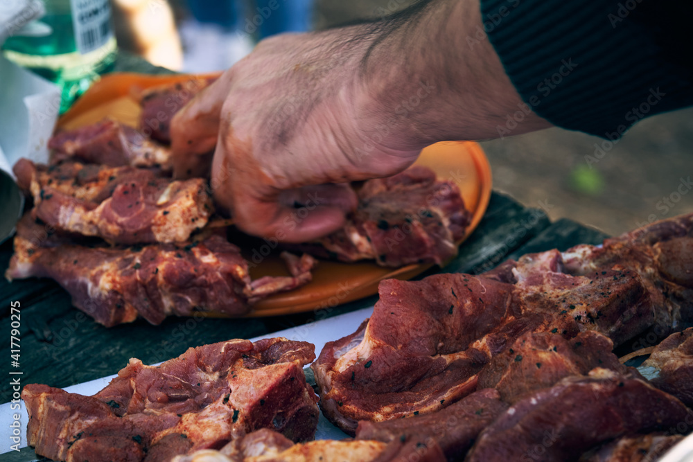 a man slices fresh raw meat