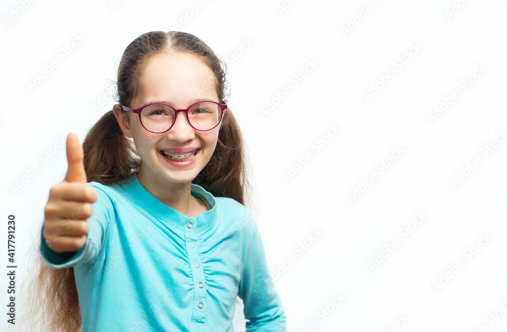 Happy smiling teen girl in blue t-shirt in eyeglasses over white background. Happy smiling teen girl in blue t-shirt in eyeglasses over white background.