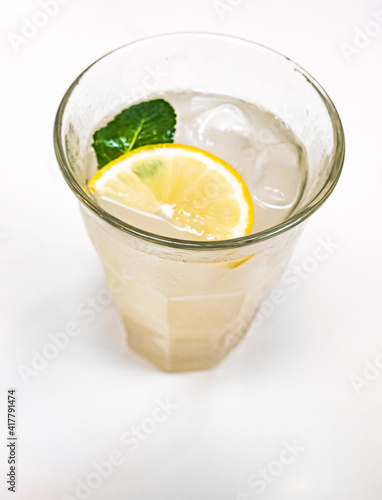 Glass Of Old Fashioned Lemonade With A Slice Of Lemon & Mint