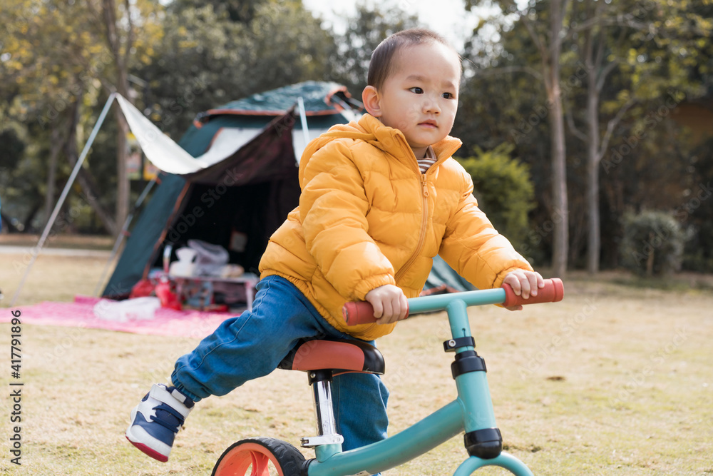 Asian Boys practice riding a balance car outdoors Asian Boys practice riding a balance car outdoors
