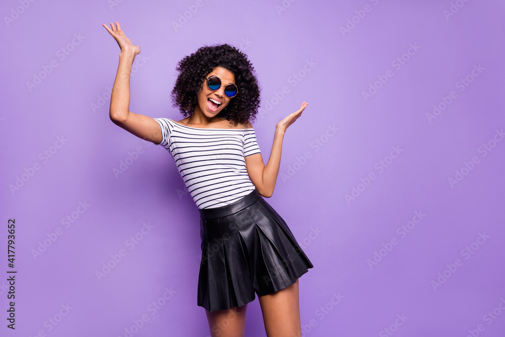 Portrait of cheerful excited dark skin lady raise hands palms open mouth smile isolated on purple color background Portrait of cheerful excited dark skin lady raise hands palms open mouth smile isolated on purple color background