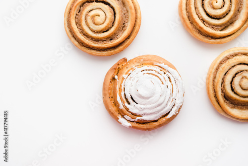 cinnamon buns on a white plate, a snail bun on a white plate