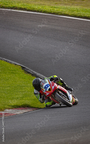 A shot of a racing motorbike as it circuits a track.