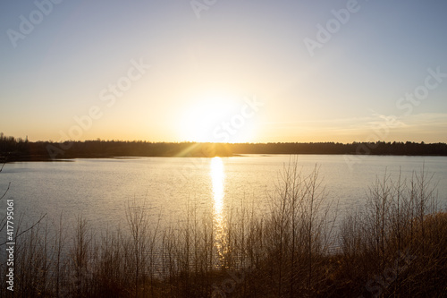 Dramatic and colorful sunset over a forest lake reflected in the water. Blakheide  Beerse  Belgium. High quality photo