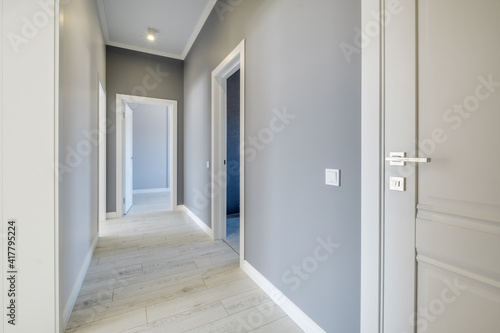 Obraz na plátně long white empty corridor in interior of entrance hall of modern apartments, off