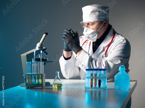 Virologist is praying. He c...