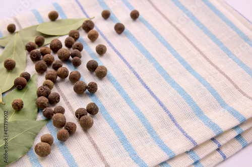 A bunch of allspice on a kitchen towel.