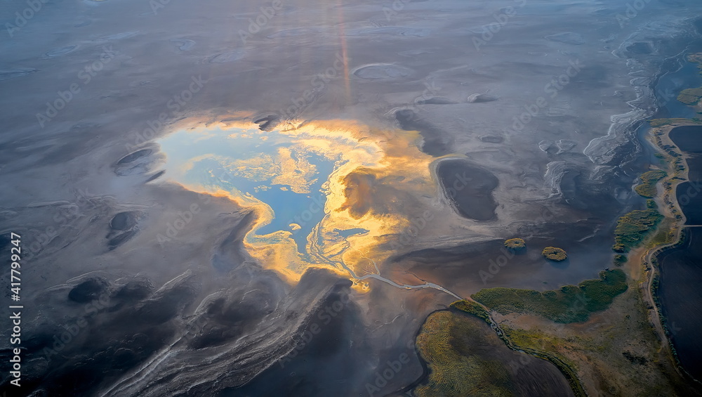 Dry lake or swamp in the process of drought and lack of rain or moisture, a global natural disaster - aerial drone view Dry lake or swamp in the process of drought and lack of rain or moisture, a global natural disaster - aerial drone view