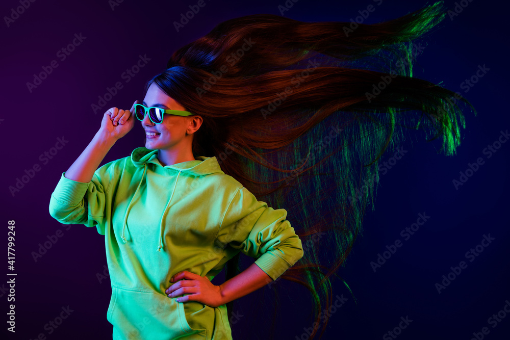 Profile side photo of happy nice woman look empty space fly hair hold hand waist isolated on colorful gradient background Profile side photo of happy nice woman look empty space fly hair hold hand waist isolated on colorful gradient background