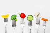 Fruit and vegetable of silver forks against a white background concept for healthy eating, dieting and antioxidant